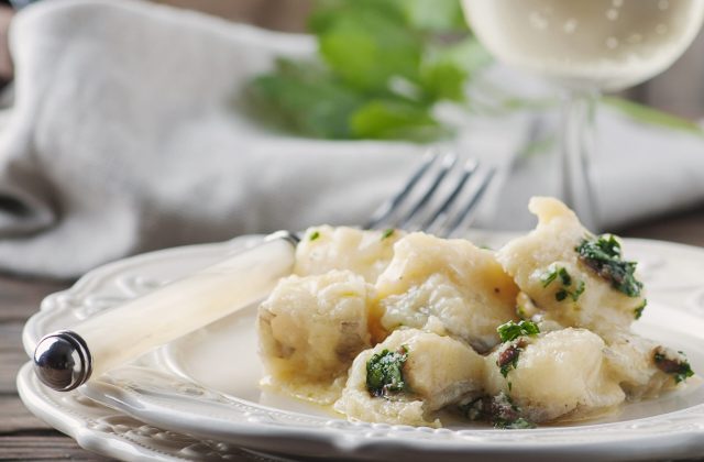 Italian traditional codfish with onion and parsley, selective focus and square image