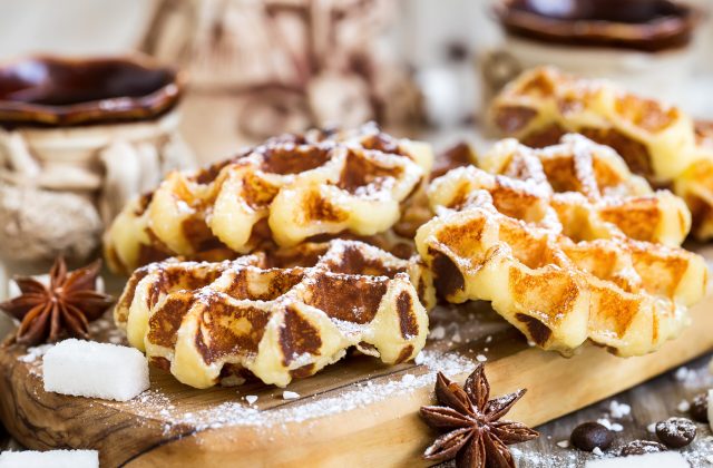 Homemade liege belgian waffers with sugar pearls and coffee on old wooden background
